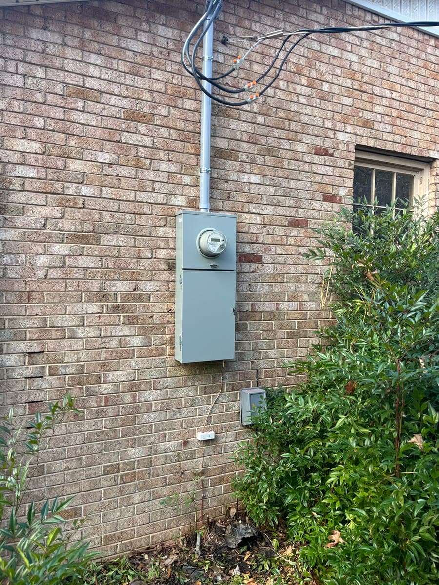 Exterior residential electrical disconnect mounted on a brick home