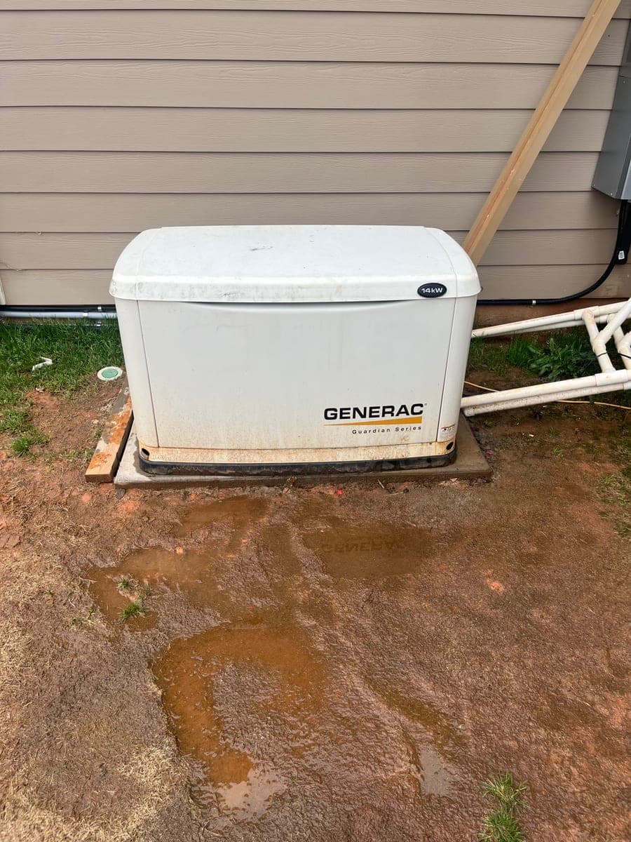 Residential standby generator installed beside a home